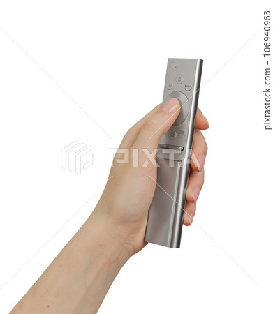 Hand holding, using remote control, TV channel turning on Hand holding, using remote control, TV channel turning on 106940963