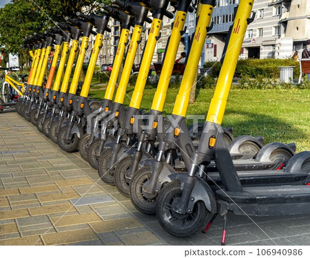 Rental kick scooters on city street 106940986