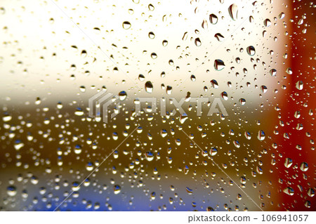 Background of a drop on the glass with colored stripes 106941057