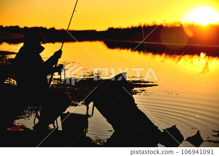 Feeder fishing. Man. The late evening. Sunset Feeder fishing. Man. The late evening. Sunset 106941091