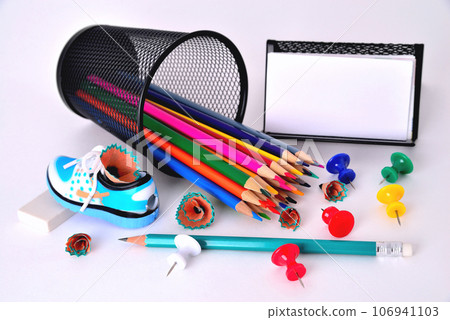 Color pencils, pencil sharpener, business card holder, eraser on white background Color pencils, pencil sharpener, business card holder, eraser on white background 106941103