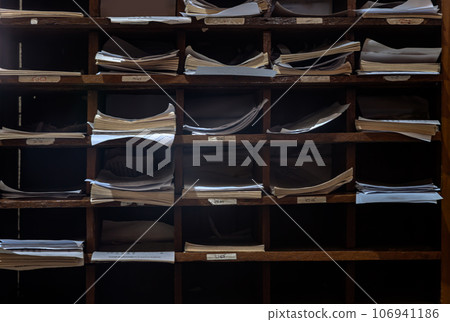 Old many books piles stacking in wooden bookshelf. Education and Learning background, 106941186