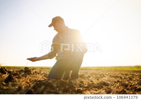 Farmer is checking soil quality before sowing. Agriculture, gardening or ecology concept. Farmer is checking soil quality before sowing. Agriculture, gardening or ecology concept. 106941379