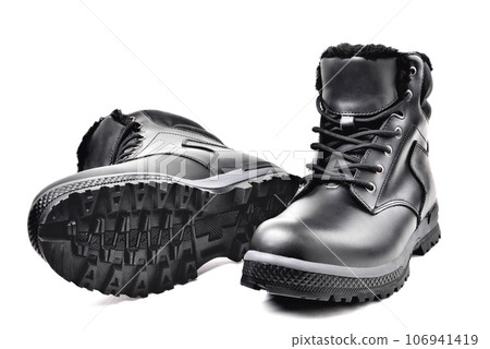 Winter mens black leather boots on a white background, hiking shoes, practical off-road shoes, close-up Winter mens black leather boots on a white background, hiking shoes, practical off-road shoes, close-up 106941419