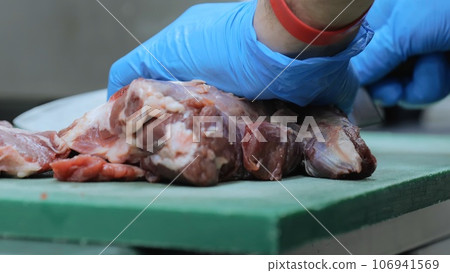 A professional cook fries meat in a pan, a cook in the kitchen prepares meat, a young man in the kitchen fries a steak, the work of a cook in the kitchen. Close-up. A professional cook fries meat in a pan, a cook in the kitchen prepares meat, a young man in the kitchen fries a steak, the work of a cook in the kitchen. Close-up. 106941569