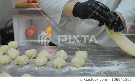 Bakery, the chef is preparing the dough, the bakery worker is preparing the dough, the cook is working with the dough in the kitchen, the cook's cookies are molding the dough for the bakery. Bakery, the chef is preparing the dough, the bakery worker is preparing the dough, the cook is working with the dough in the kitchen, the cook's cookies are molding the dough for the bakery. 106941595