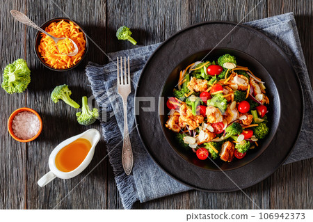 fried chicken tenders broccoli salad in bowl fried chicken tenders broccoli salad in bowl 106942373