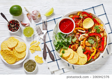 chicken fajitas with peppers, onion, taco chips chicken fajitas with peppers, onion, taco chips 106942376