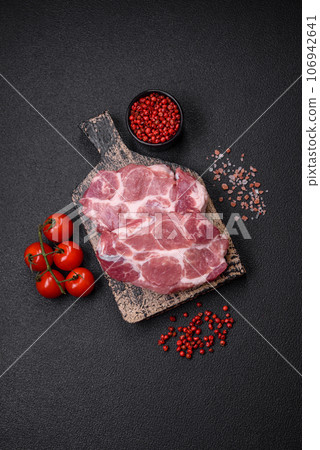 Fresh juicy pork steaks with salt, spices and herbs Fresh juicy pork steaks with salt, spices and herbs 106942641