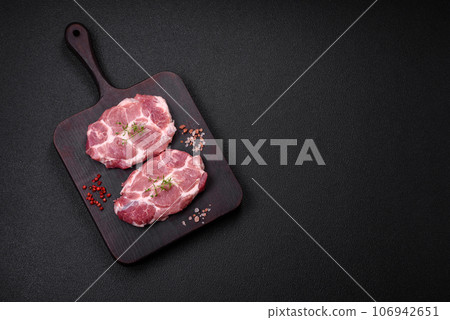 Fresh juicy pork steaks with salt, spices and herbs Fresh juicy pork steaks with salt, spices and herbs 106942651