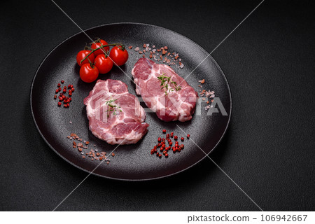 Fresh juicy pork steaks with salt, spices and herbs Fresh juicy pork steaks with salt, spices and herbs 106942667