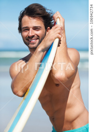 Portrait, surf and a man in the ocean at the beach with his surfboard while on summer vacation or holiday. Face, smile and body with a happy young male surfer shirtless outdoor by the sea for surfing Portrait, surf and a man in the ocean at the beach with his surfboard while on summer vacation or holiday. Face, smile and body with a happy young male surfer shirtless outdoor by the sea for surfing 106942734