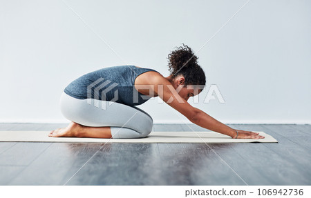 Yoga, child pose and woman for wellness, workout and stretching on mat in gym studio. Healthy body, meditation and calm female person doing pilates exercise for balance, flexibility and wellbeing Yoga, child pose and woman for wellness, workout and stretching on mat in gym studio. Healthy body, meditation and calm female person doing pilates exercise for balance, flexibility and wellbeing 106942736