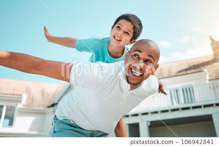 Father and child playing airplane outdoor as family in backyard of house with a smile, love and care. Man and boy kid for game, security and quality time with happiness and arms outstretched on sky Father and child playing airplane outdoor as family in backyard of house with a smile, love and care. Man and boy kid for game, security and quality time with happiness and arms outstretched on sky 106942841