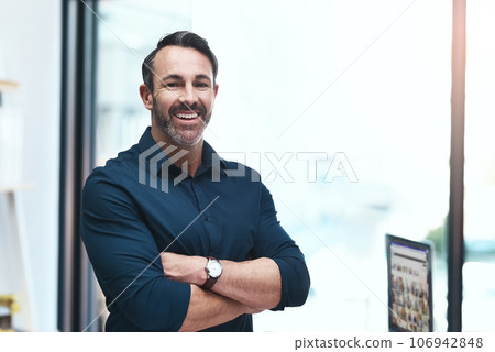 Im building my own empire. Portrait of a mature businessman standing in his office. Im building my own empire. Portrait of a mature businessman standing in his office. 106942848