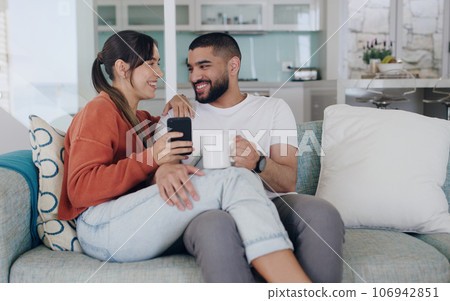 Happy, couple and cellphone on sofa in living room with social media post, online subscription and mobile app. Man, woman and smartphone for digital connection, technology and coffee to relax at home Happy, couple and cellphone on sofa in living room with social media post, online subscription and mobile app. Man, woman and smartphone for digital connection, technology and coffee to relax at home 106942851
