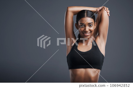 Portrait, mockup and stretching with an athlete woman in studio on a gray background for fitness or health. Exercise, workout and warm up with an attractive young female model training her body 106942852