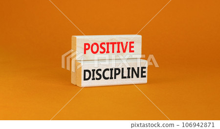 Positive discipline symbol. Concept words Positive discipline on beautiful wooden blocks. Beautiful orange table orange background. Business psychology positive discipline concept. Copy space. 106942871