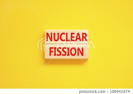 Nuclear fission symbol. Concept words Nuclear fission on beautiful wooden blocks. Beautiful yellow table yellow background. Business science nuclear fission concept. Copy space. 106942874