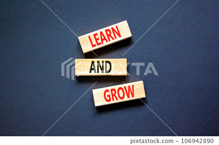 Learn and grow symbol. Concept word Learn And Grow on beautiful wooden block. Beautiful black table black background. Business, education learn and grow concept. Copy space. 106942890