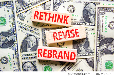 Rethink revise rebrand symbol. Concept word Rethink Revise Rebrand on block. Dollar bills. Beautiful dollar bills background. Business brand motivational rethink revise rebrand concept. Copy space. Rethink revise rebrand symbol. Concept word Rethink Revise Rebrand on block. Dollar bills. Beautiful dollar bills background. Business brand motivational rethink revise rebrand concept. Copy space. 106942892