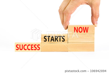 Success starts now symbol. Concept word Success starts now on beautiful wooden block. Businessman hand. Beautiful white table background. Business motivational success starts now concept. Copy space. Success starts now symbol. Concept word Success starts now on beautiful wooden block. Businessman hand. Beautiful white table background. Business motivational success starts now concept. Copy space. 106942894