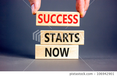 Success starts now symbol. Concept word Success starts now on beautiful wooden block. Businessman hand. Beautiful grey table background. Business motivational success starts now concept. Copy space. 106942901