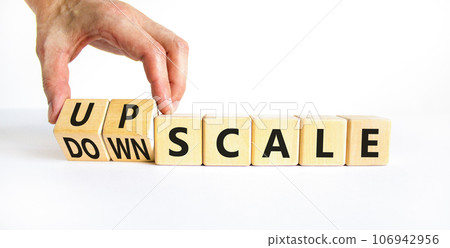 Upscale or downscale symbol. Concept words Upscale or Downscale on wooden cubes. Beautiful white table white background. Businessman hand. Business upscale or downscale concept. Copy space. Upscale or downscale symbol. Concept words Upscale or Downscale on wooden cubes. Beautiful white table white background. Businessman hand. Business upscale or downscale concept. Copy space. 106942956