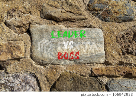 Boss vs leader symbol. Concept words Boss vs versus leader on beautiful big stone on stone wall. Beautiful stone wall background. Business motivational boss vs leader concept. Copy space. 106942958