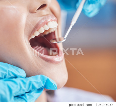 Show me those canines. Shot of a woman about to have her teeth checked by the dentist. Show me those canines. Shot of a woman about to have her teeth checked by the dentist. 106943032