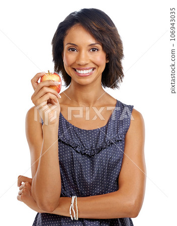 Portrait, studio or black woman eating an apple against a white background with marketing mockup space. Fruit, organic or happy African girl advertising healthy food or diet for self care or wellness Portrait, studio or black woman eating an apple against a white background with marketing mockup space. Fruit, organic or happy African girl advertising healthy food or diet for self care or wellness 106943035