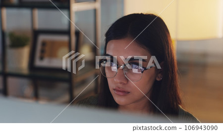 Computer, night and face with a woman journalist working in her office for editing a news report. Focus, editing and reporting with a young female editor at work on a desktop for online content 106943090