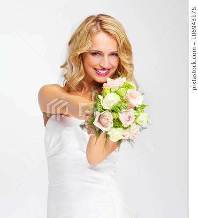 Its the perfect bouquet. Gorgeous young bride holding out her bouquet towards you - portrait. Its the perfect bouquet. Gorgeous young bride holding out her bouquet towards you - portrait. 106943178
