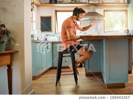 Hello, laptop and video call with man in kitchen for online meeting, remote work and virtual communication. Happy, wave and social media with person at home for technology, streaming and entrepreneur 106943267