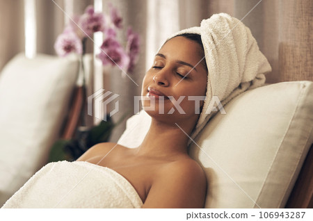 Spa, woman and relax with eyes closed for calm, zen and peace for physical therapy, health and wellness. Female customer with smile, luxury and towel for a holistic massage and hospitality at a salon Spa, woman and relax with eyes closed for calm, zen and peace for physical therapy, health and wellness. Female customer with smile, luxury and towel for a holistic massage and hospitality at a salon 106943287