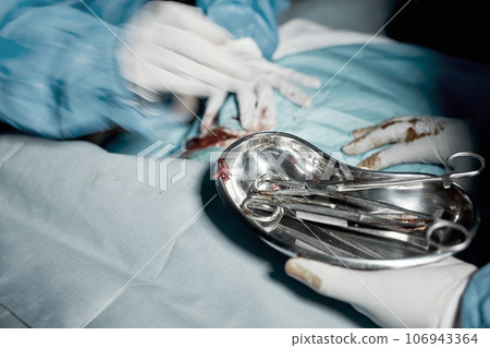 Operation, blood and motion blur with doctors hands in a hospital for medical or life saving surgery. Healthcare, emergency or teamwork between a doctor and medicine team in a clinic ER theater Operation, blood and motion blur with doctors hands in a hospital for medical or life saving surgery. Healthcare, emergency or teamwork between a doctor and medicine team in a clinic ER theater 106943364