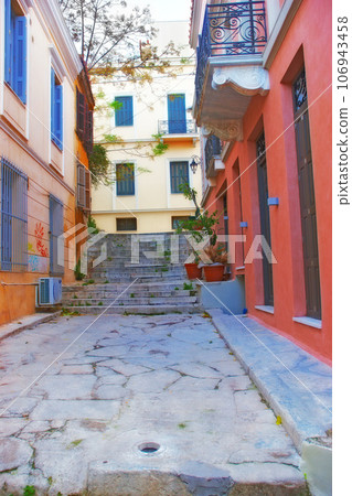 View of an empty street alley between city buildings abroad in Germany. Narrow concrete road, stone steps in an old small overseas village. Exploring town and enjoying holiday and vacation in Europe 106943458