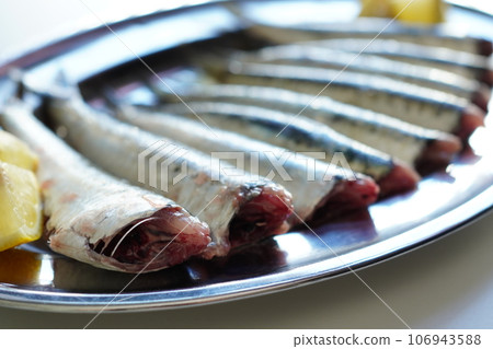 Fresh sardines prepared and uncooked on a silver tray Fresh sardines prepared and uncooked on a silver tray 106943588