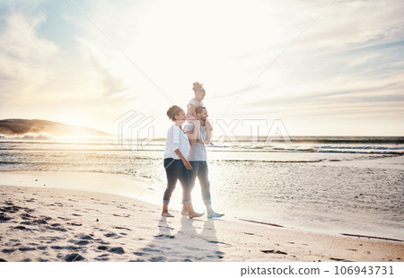 Walking, sunset and family on the beach for vacation, adventure or holiday together for bonding. Travel, having fun and girl child with her mother and father on the sand by the ocean on weekend trip. 106943731