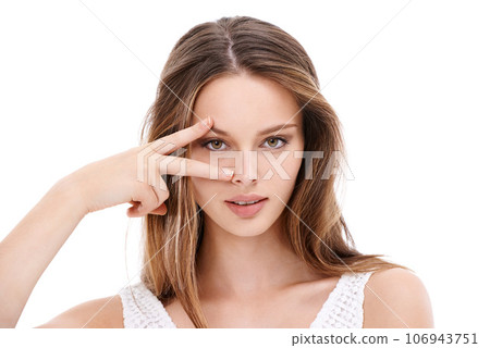 Portrait, hand and eyes with a model woman in studio on a white background with her fingers on her face. Microblading, eyecare and beauty with an attractive young female posing to promote cosmetics Portrait, hand and eyes with a model woman in studio on a white background with her fingers on her face. Microblading, eyecare and beauty with an attractive young female posing to promote cosmetics 106943751