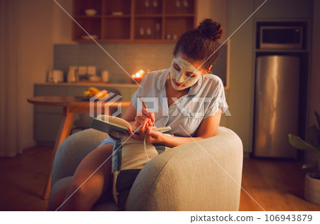 Selfcare, grooming and creative writing by a woman making notes in diary while giving herself a facial. Relaxed female planning ideas for a novel in a journal, enjoying free time and a calming hobby 106943879