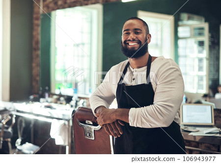 Barber shop employee, hair stylist and black man portrait of an entrepreneur with smile. Salon, professional worker and male person face with happiness and proud from small business and beauty parlor Barber shop employee, hair stylist and black man portrait of an entrepreneur with smile. Salon, professional worker and male person face with happiness and proud from small business and beauty parlor 106943977