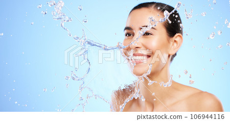Water splash, smile or happy girl with face wash for skincare or hygiene on blue background in studio. Banner, mockup or woman with wellness cleaning or washing in beauty grooming or facial treatment 106944116
