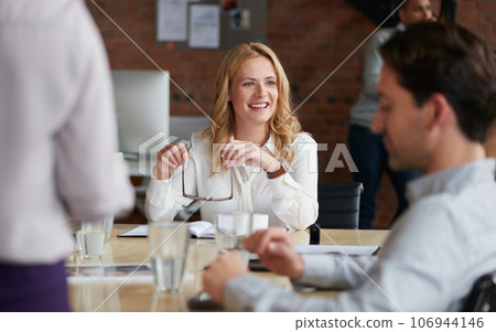 Inspired to keep crafting success with her team. Shot of a young businesswoman having a meeting with her colleagues in an office. Inspired to keep crafting success with her team. Shot of a young businesswoman having a meeting with her colleagues in an office. 106944146