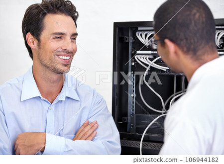 Server room, it support and network with an engineer talking to a business man about cyber security. Database, consulting and maintenance with a technician chatting about information technology 106944182