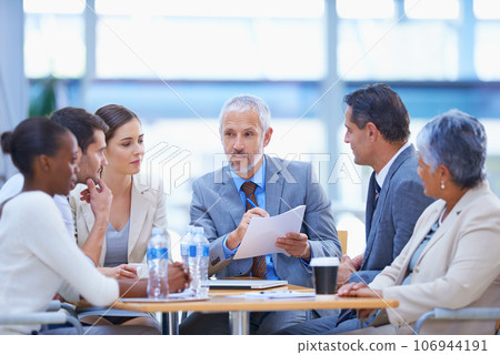 Taking a look at the costs and benefits. A cropped shot of a diverse group of businesspeople having a meeting. Taking a look at the costs and benefits. A cropped shot of a diverse group of businesspeople having a meeting. 106944191