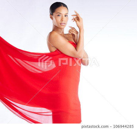Fabric, red and portrait of woman for beauty, fashion and style isolated against a studio white background. Female, African and young model with cloth as a dress in luxury and glow on skin 106944285