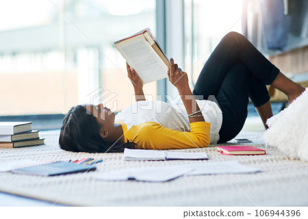 Books, relax student and woman reading literature, research or book for home school education, study or college. Learning commitment, university and person studying knowledge while lying on floor Books, relax student and woman reading literature, research or book for home school education, study or college. Learning commitment, university and person studying knowledge while lying on floor 106944396