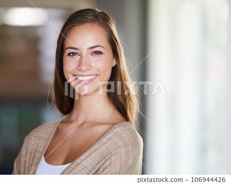 Keeping it natural and nonchalant. Shot of an attractive young woman relaxing at home. 106944426