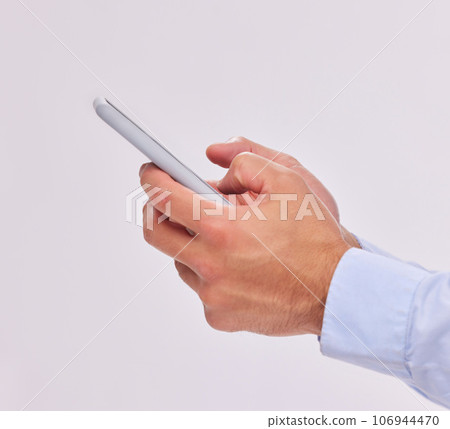 Hands, technology and typing with phone in studio isolated on a white background. Cellphone, networking and male or man with mobile smartphone for texting, social media or internet browsing online 106944470